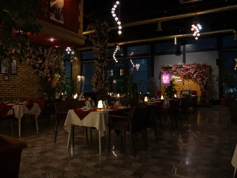 Meyhane dining room with candlelit tables and brick arches