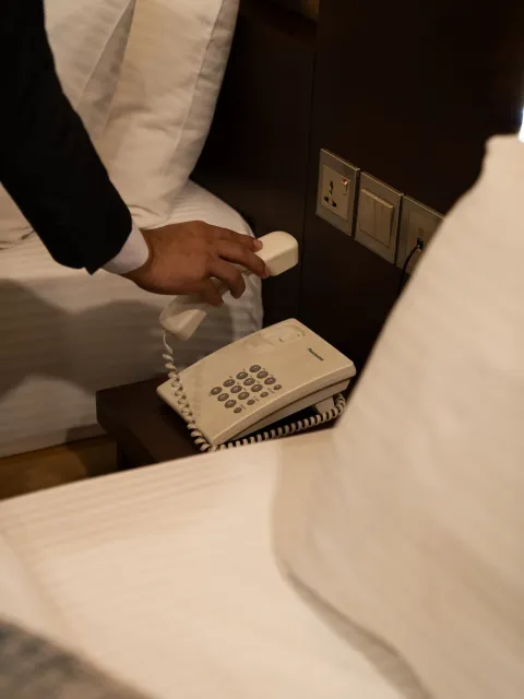Staff answering the in-room telephone for a guest request